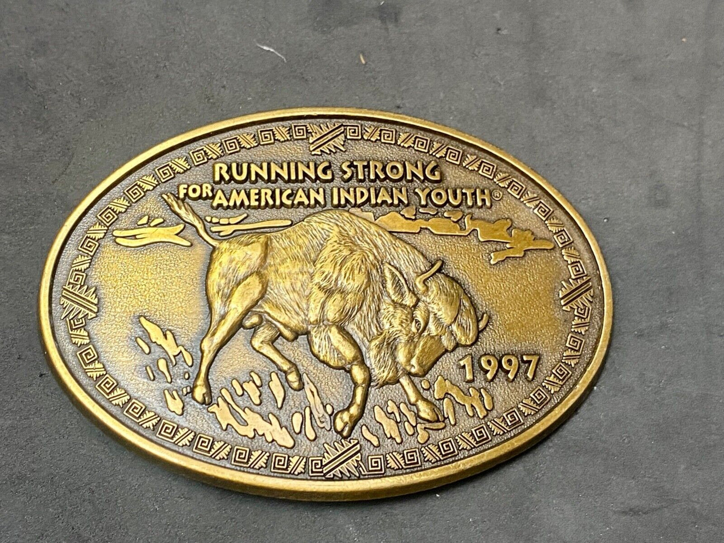 Vintage 1997 BUFFALO belt buckle RUNNING STRONG FOR AMERICAN INDIAN YOUTH