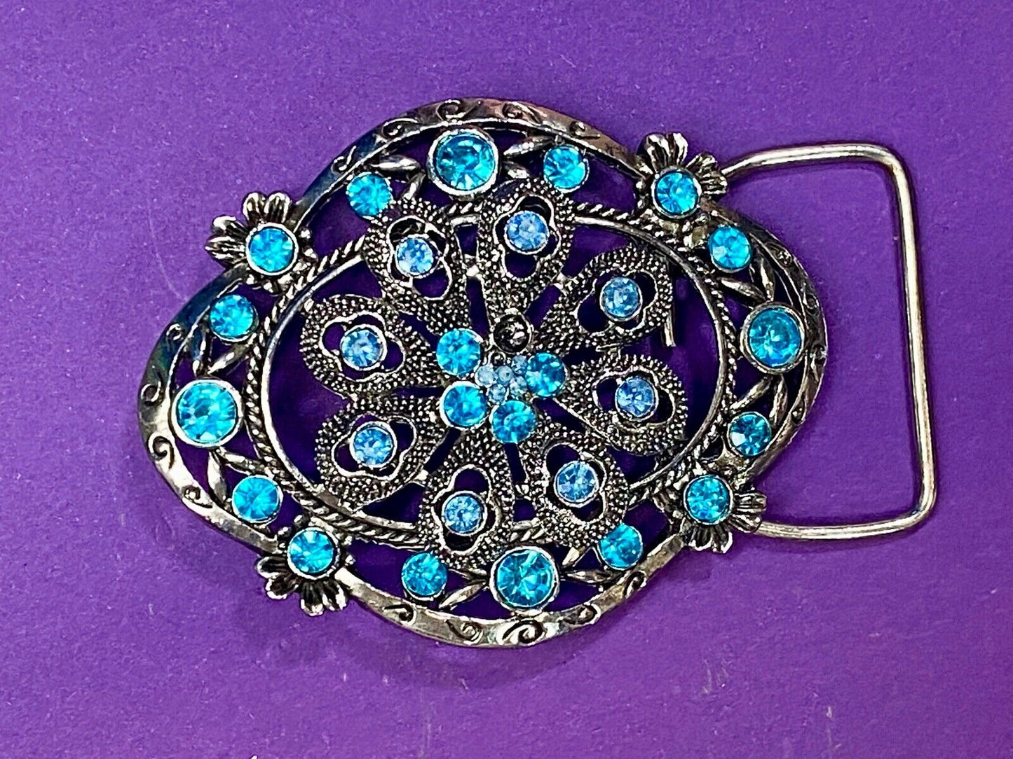 BEAUTIFUL BLUE rhinestones mounted in oval shaped flower theme belt buckle