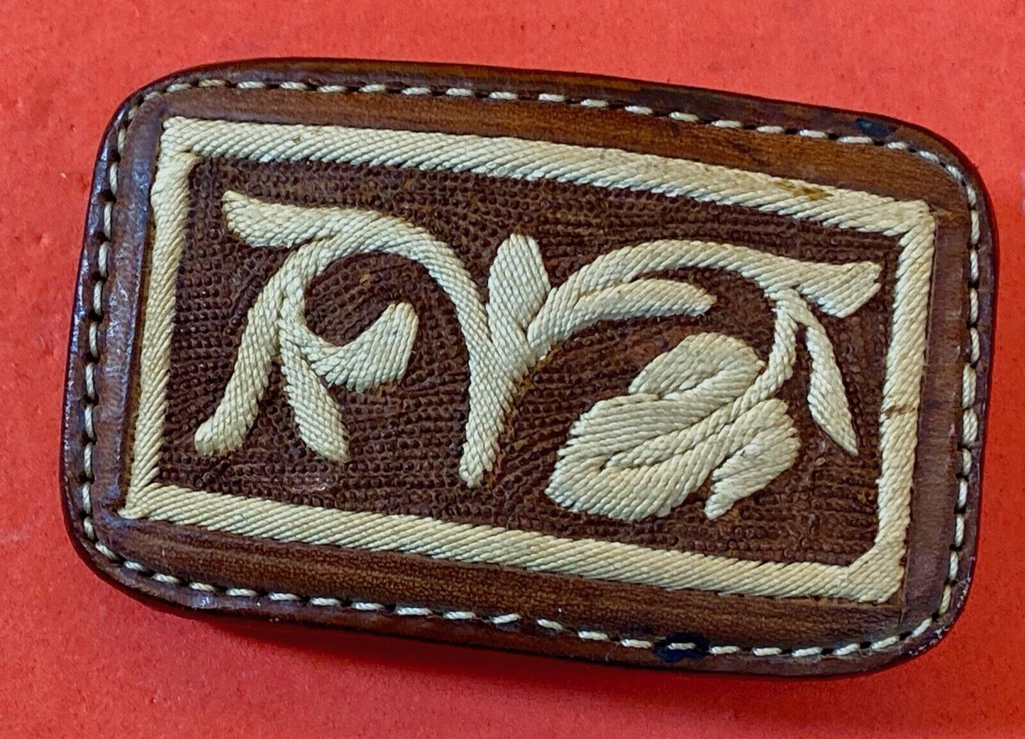 Vintage embroidered flower theme on brown leather belt buckle
