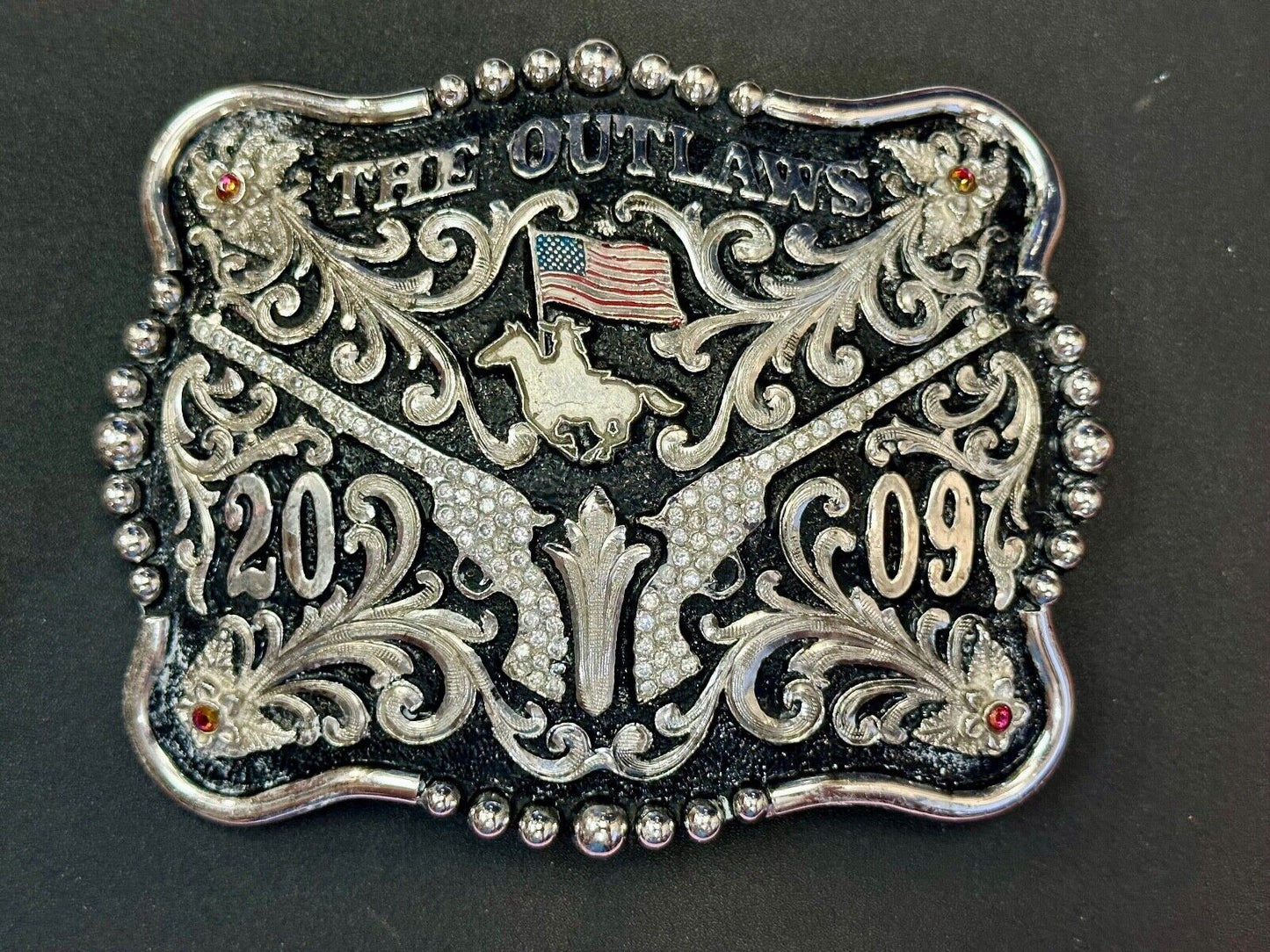 The Outlaws Rodeo Cowboy Trophy 2009 Flag Belt Buckle - Crossroads bucklesTexas