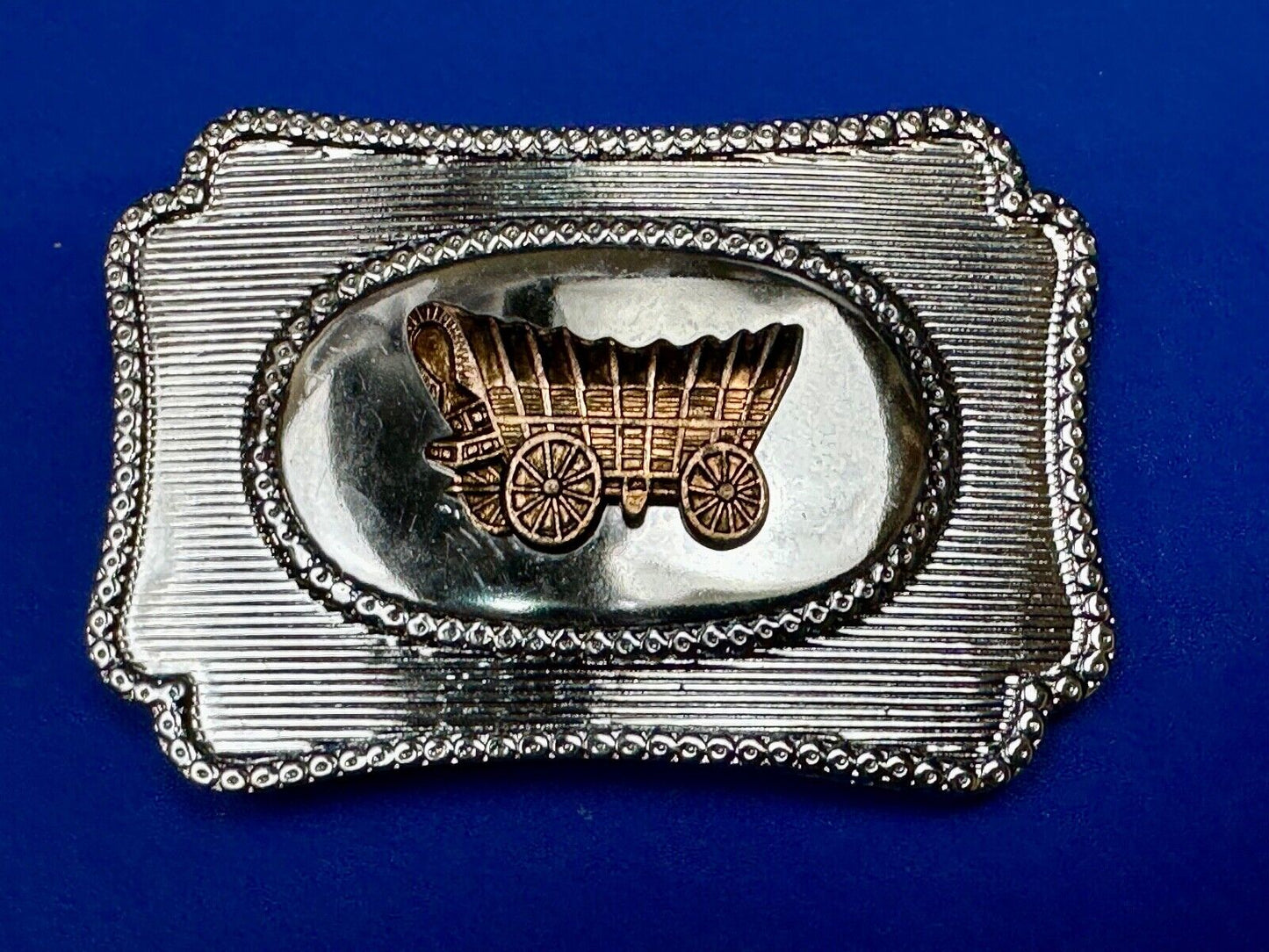 Vintage covered wagon western horse drawn transportation belt buckle