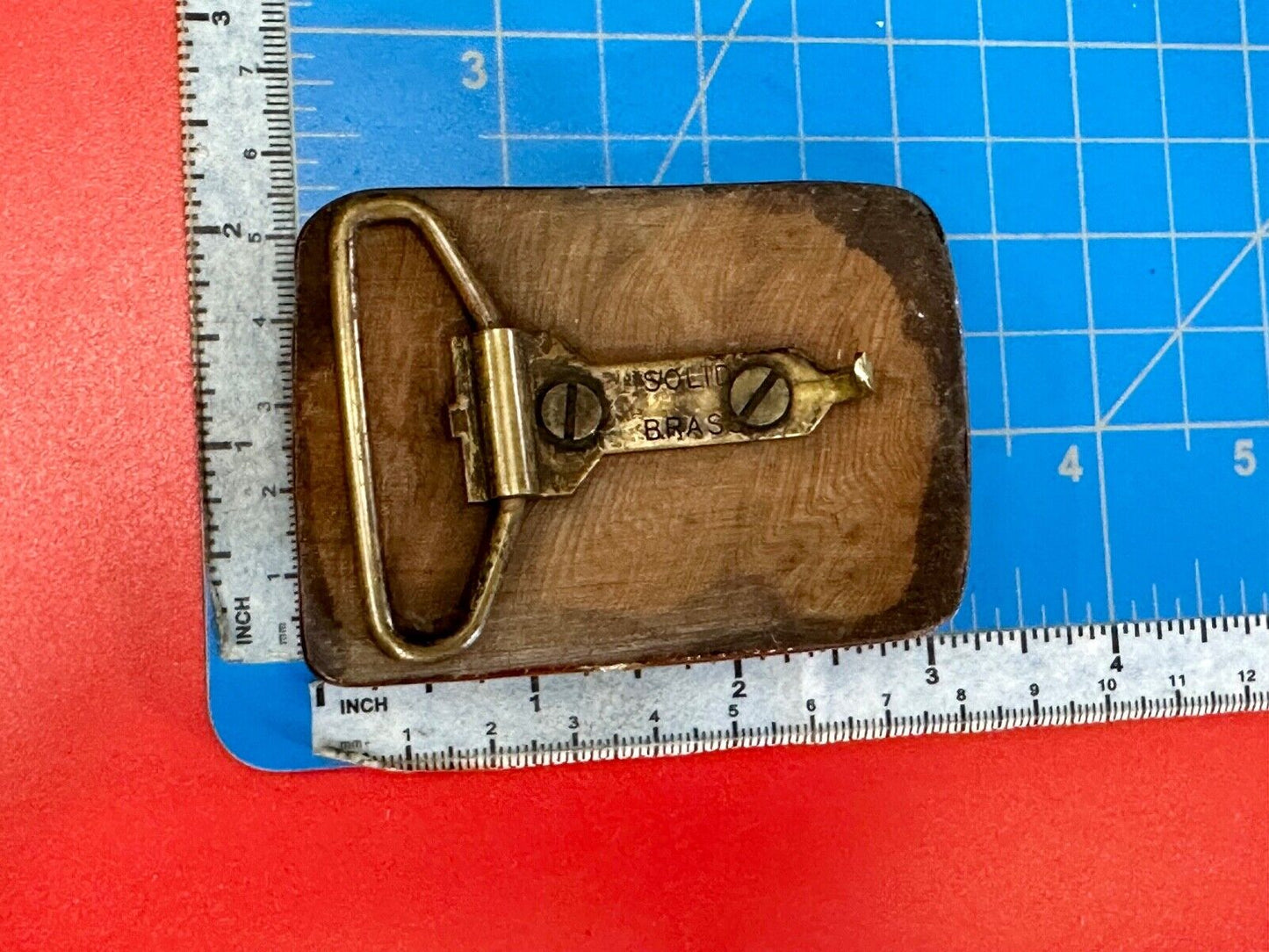 Artisan wooden glossy wood belt buckle with gold color artist scene?