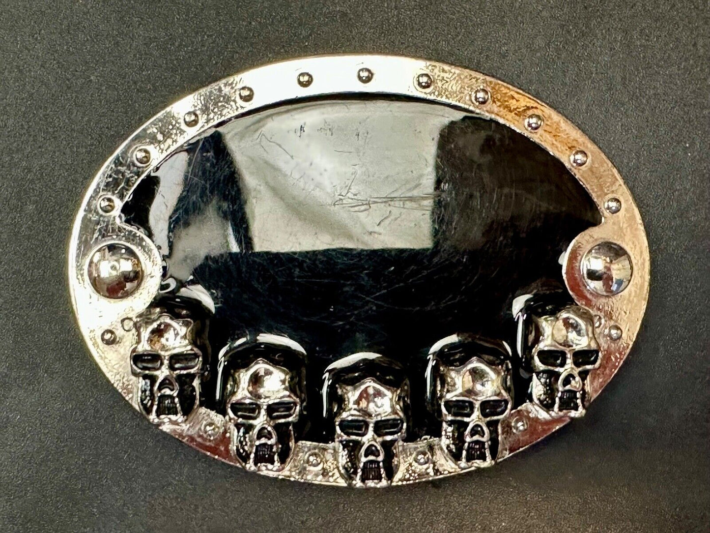 Black and silver Belt Buckle with multiple skulls on boarder