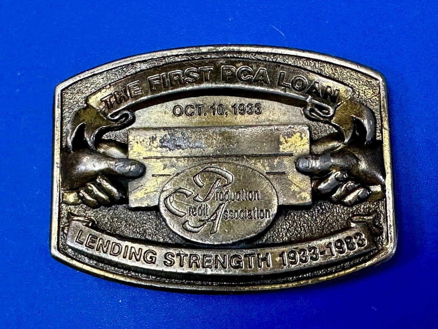 The First PCA loan Production Credit - Vintage The Great American Belt Buckle Co