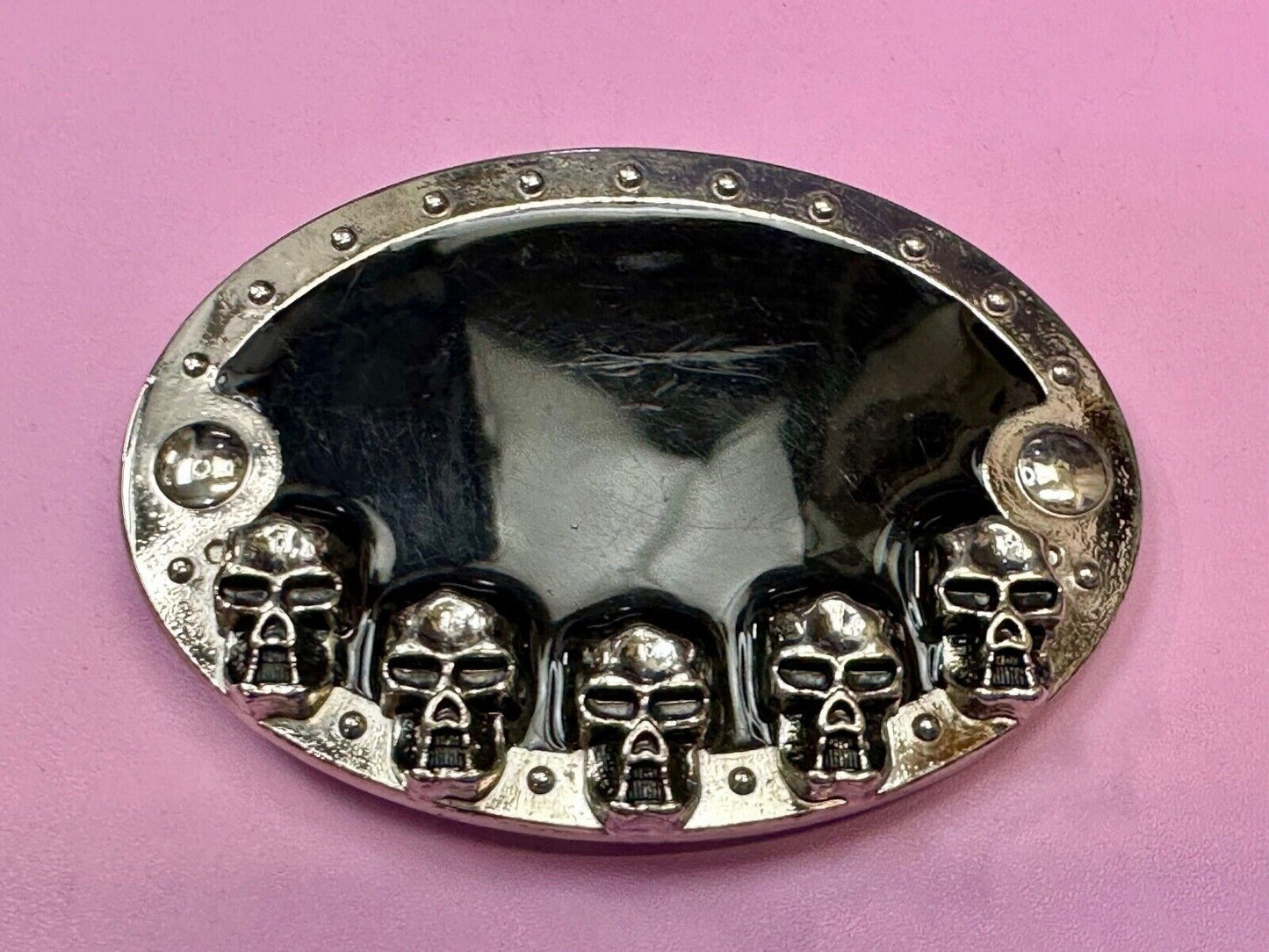 Black and silver Belt Buckle with multiple skulls on boarder