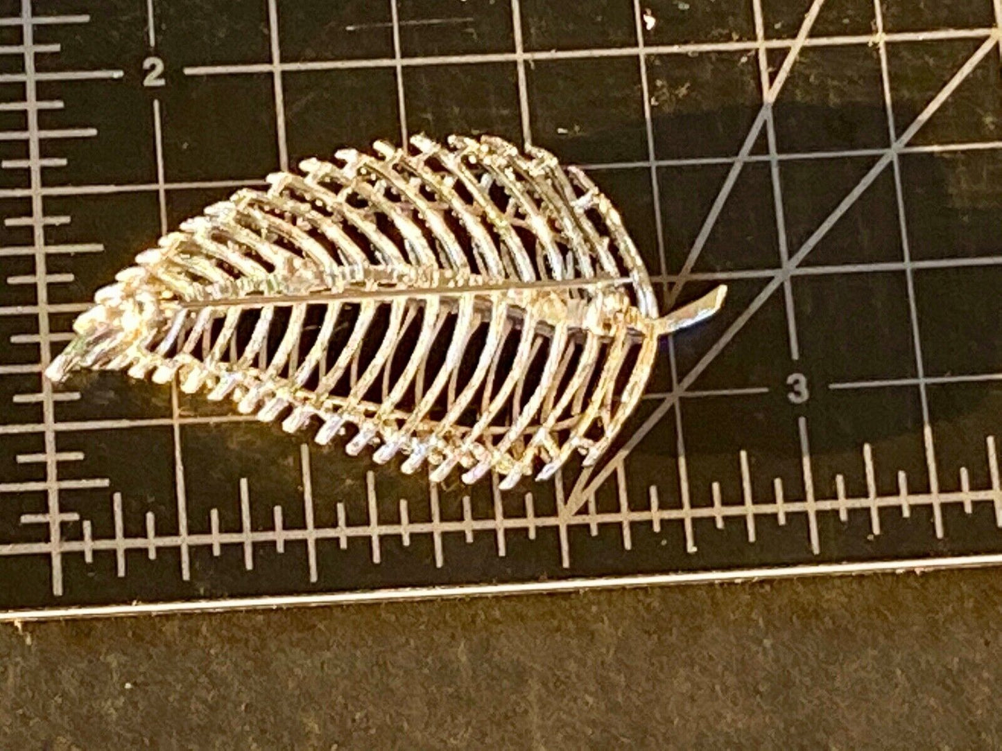 SWP INC signed Gold tone skeleton see through leaf brooch