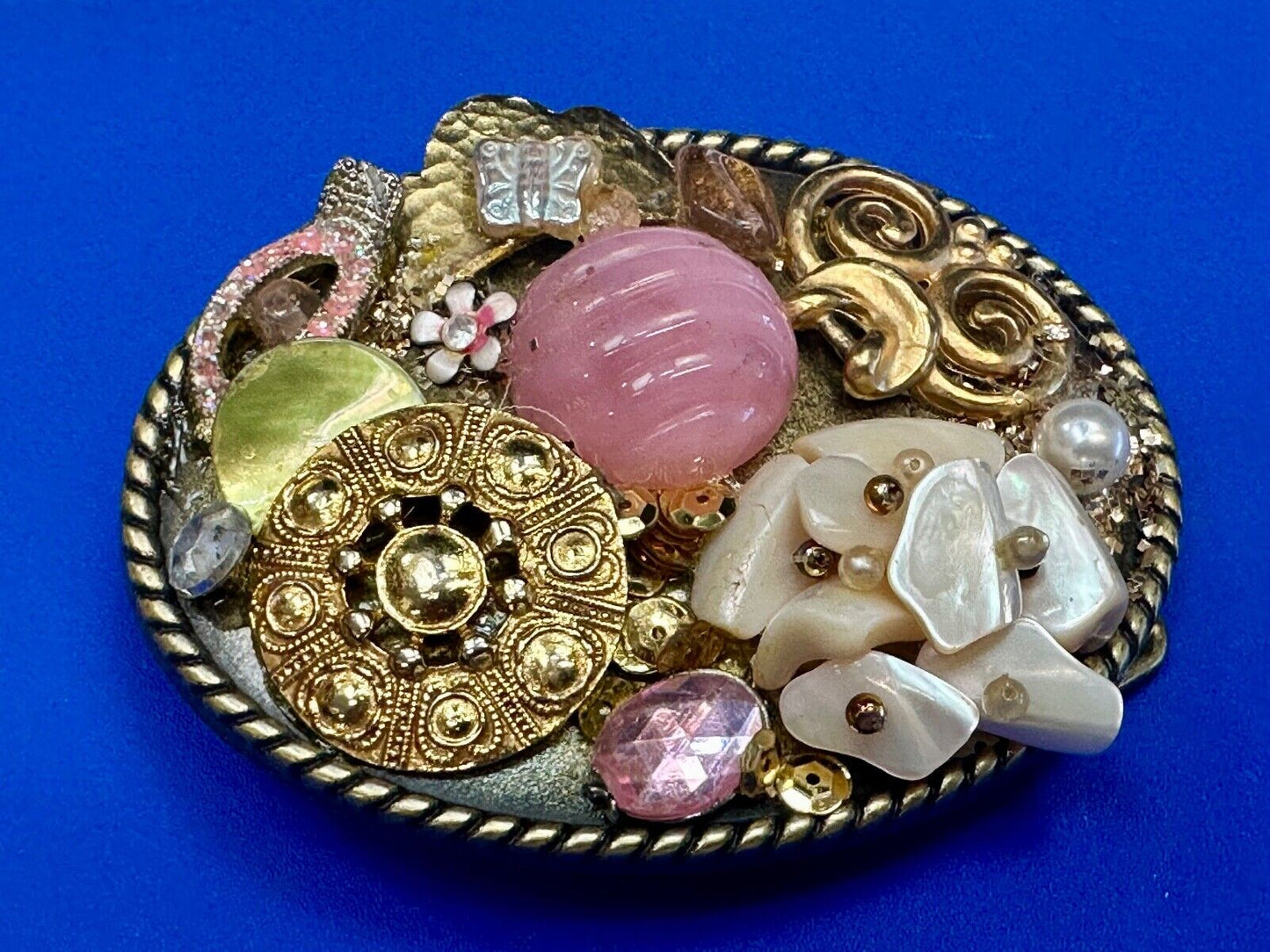Artisan Abstract flowers made of mixed material on gold tone oval belt buckle