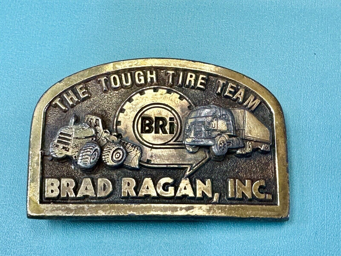 The Tough Tire Team BRi Brad Ragan, Inc. vintage belt buckle by Spec-Cast