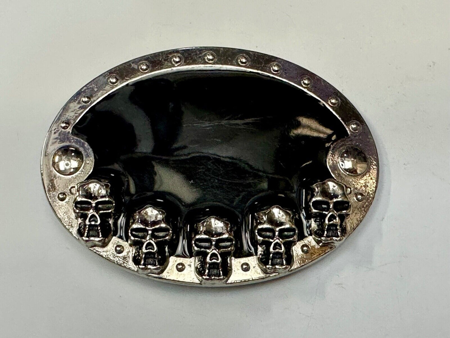 Black and silver Belt Buckle with multiple skulls on boarder