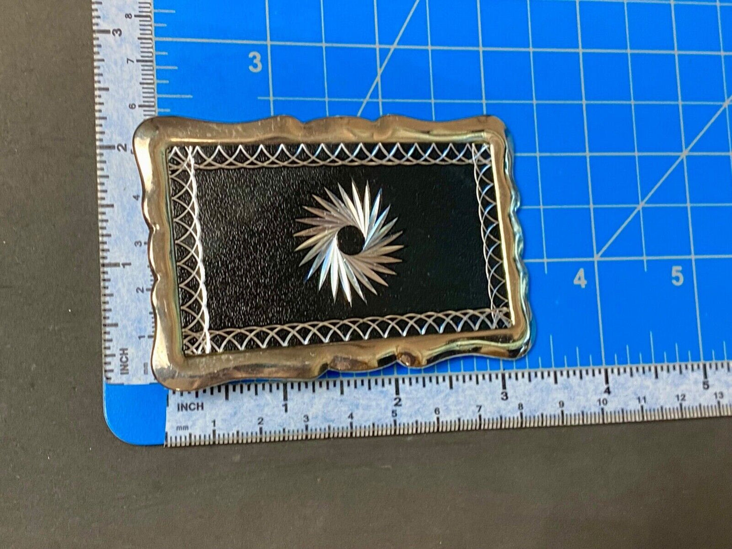 Black and silver color etched starburst pattern rectangular belt buckle