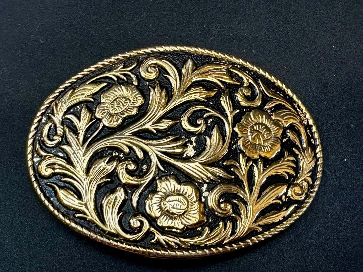Vintage black and gold tone western flower floral theme cowboys belt buckle