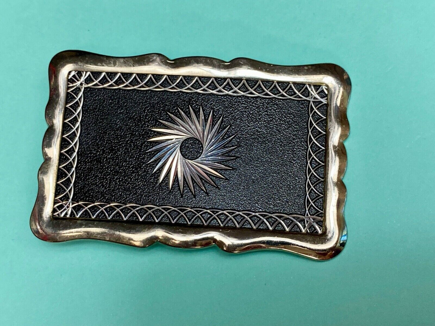 Black and silver color etched starburst pattern rectangular belt buckle