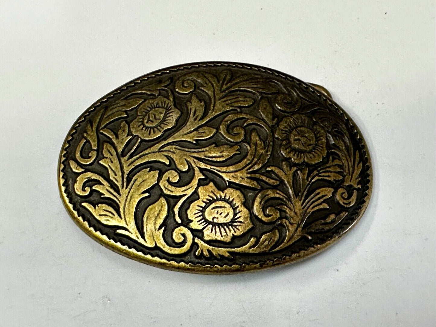 Vintage black and gold tone western flower floral theme cowboys belt buckle