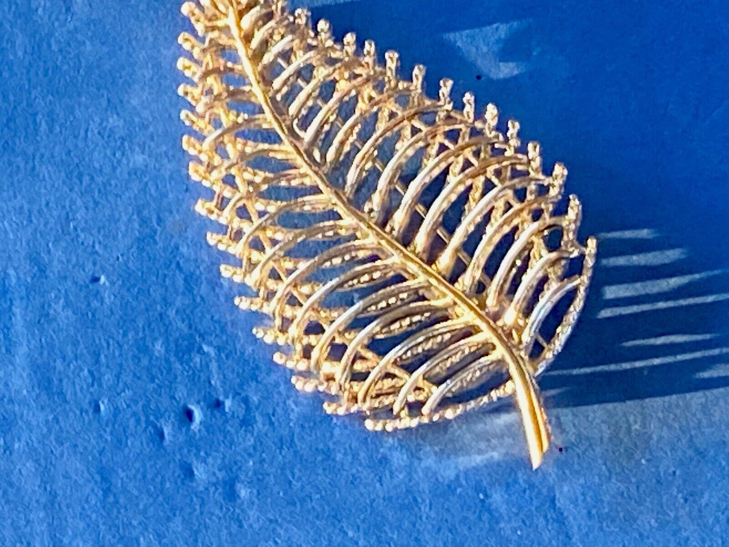 SWP INC signed Gold tone skeleton see through leaf brooch