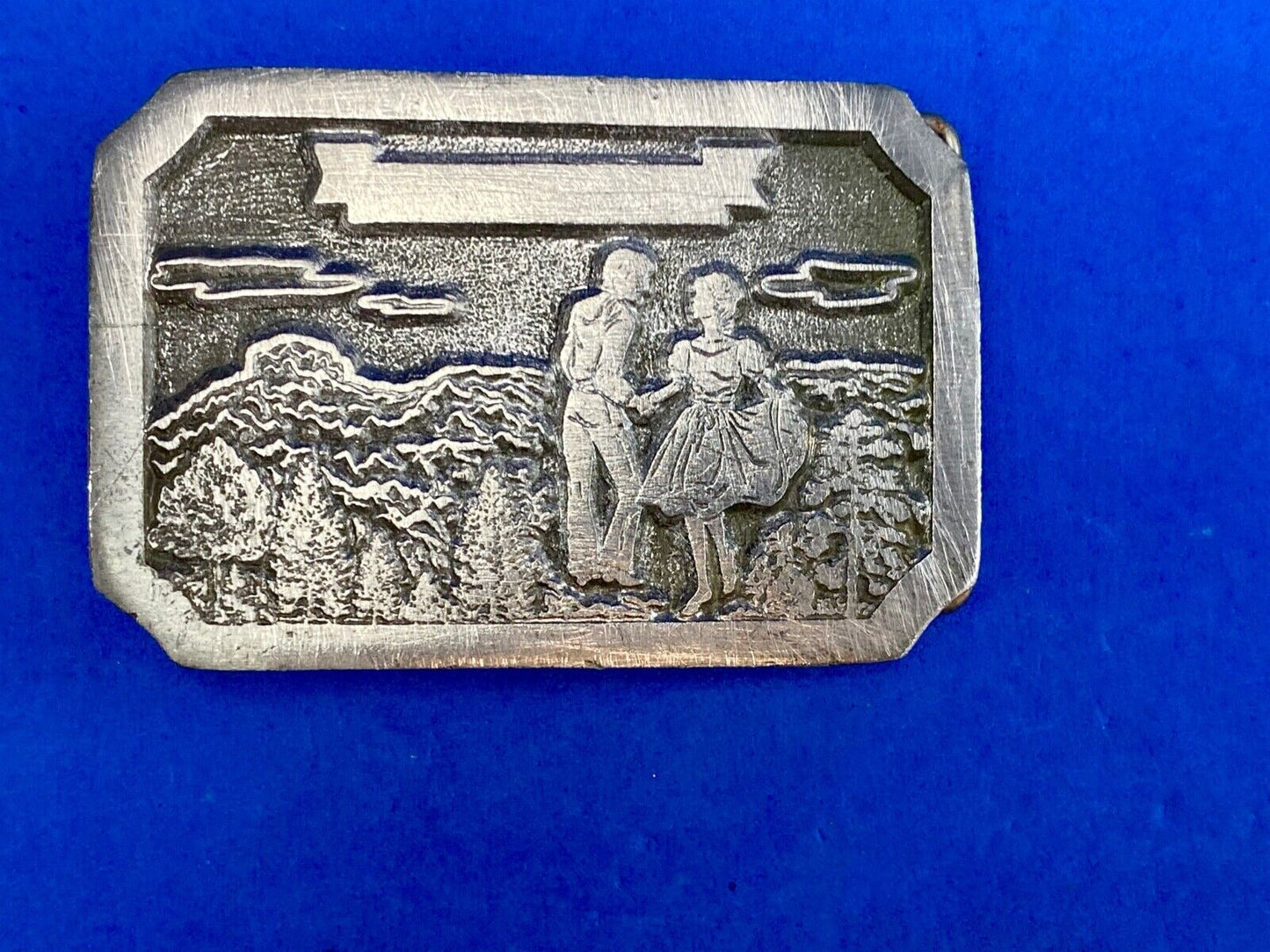 Vintage daleco belt buckle featuring a dancing couple