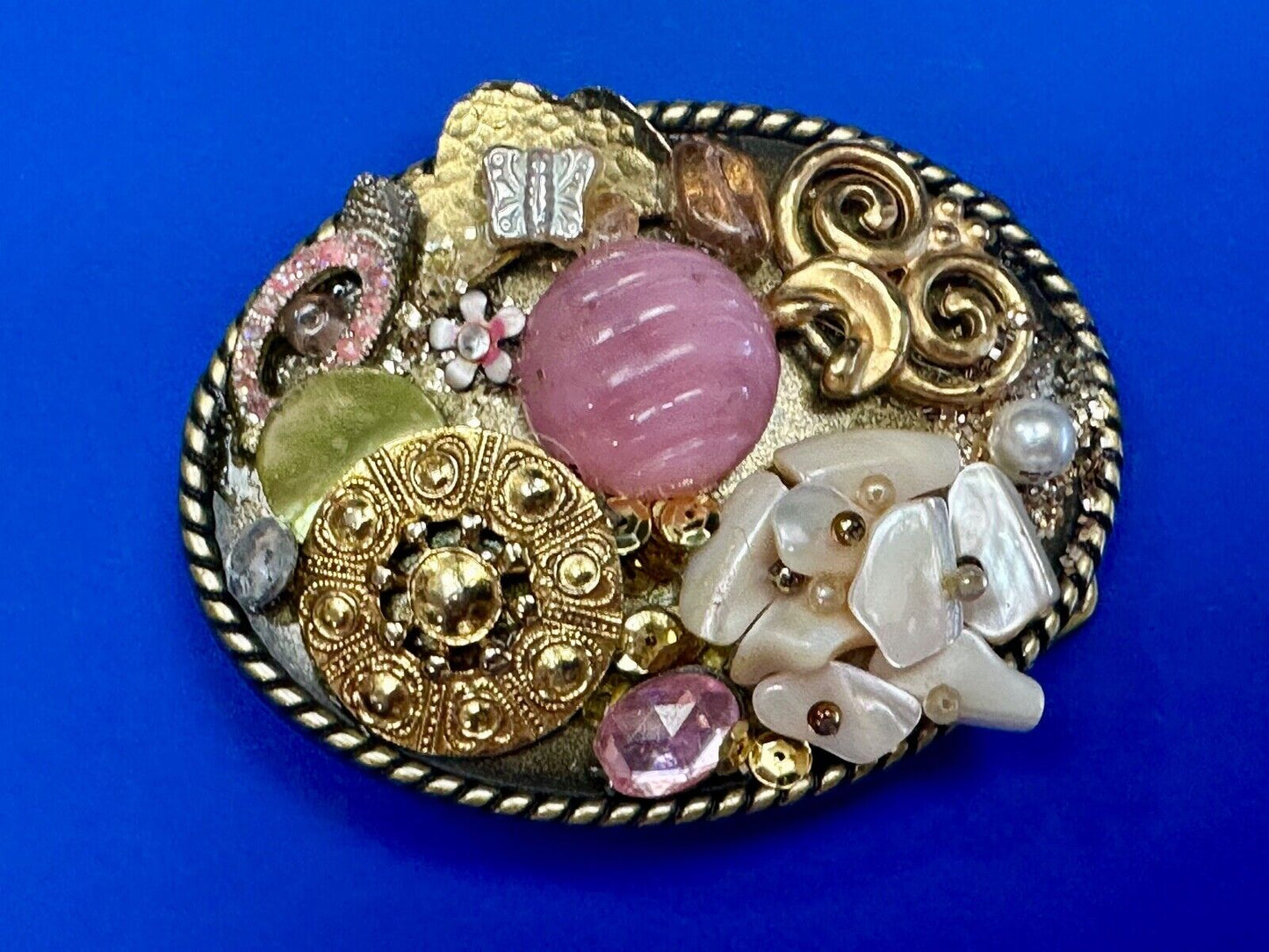 Artisan Abstract flowers made of mixed material on gold tone oval belt buckle