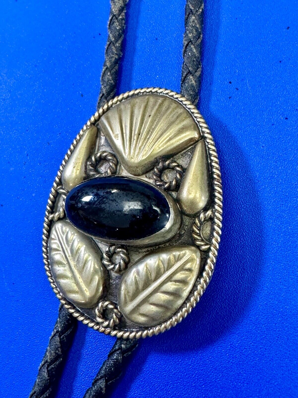 Beautiful Alpaca Mexico bolo tie with dimensional raised leaf's black stone