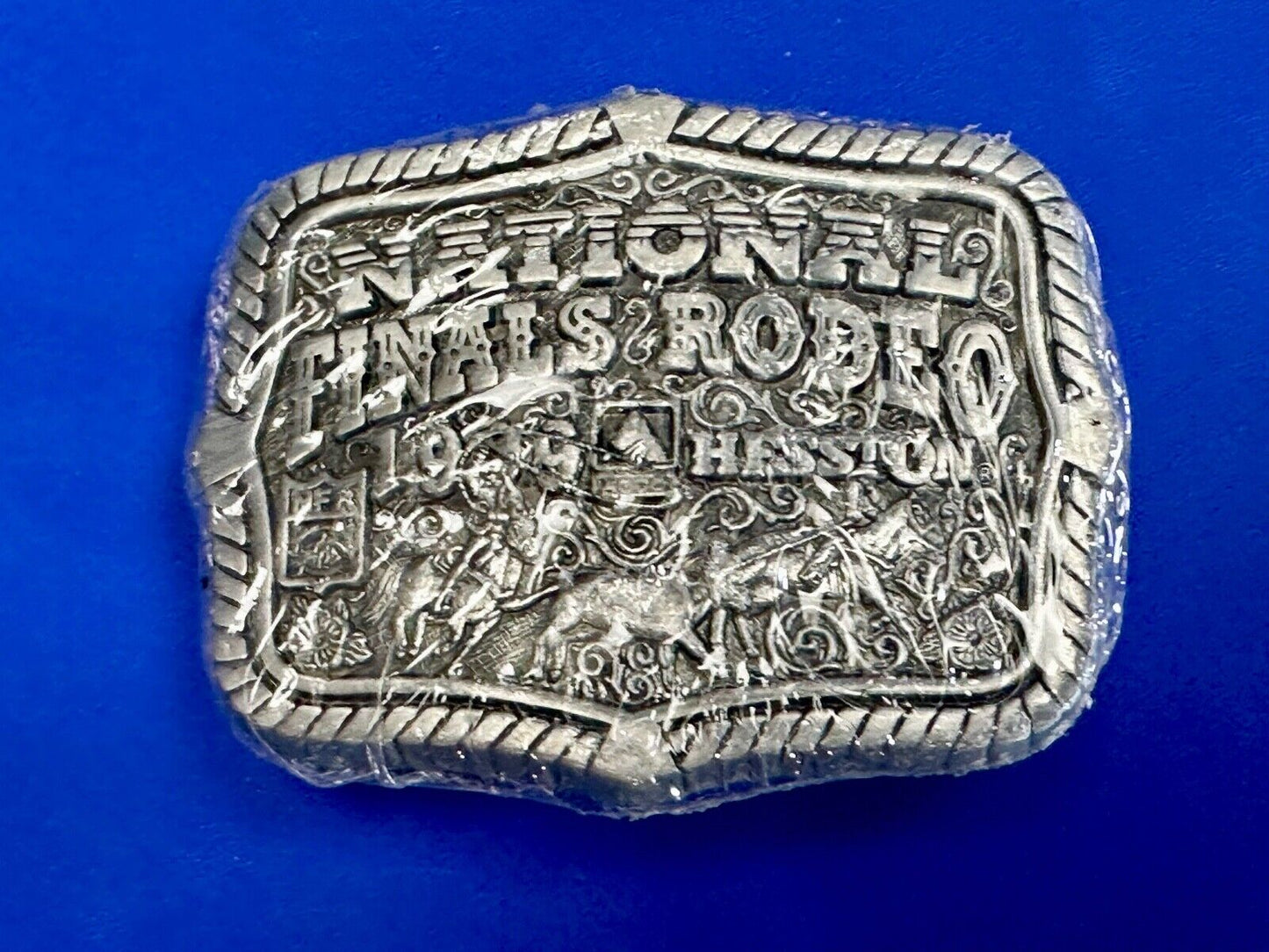 1999 Youth Sized Hesston National Finals Rodeo 2000 series belt buckle in wrap