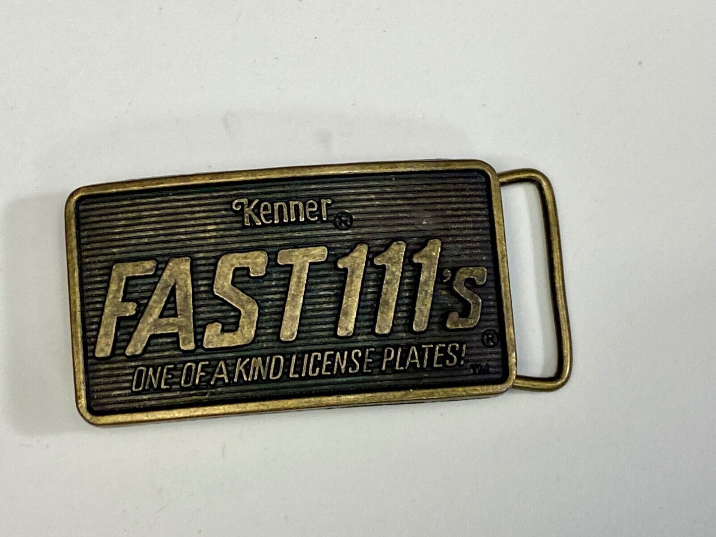 1982 Kenner Fast 111'S Company Advertisement Belt Buckle License Plates