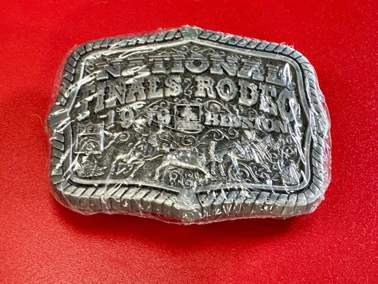 1999 Youth Sized Hesston National Finals Rodeo 2000 series belt buckle in wrap