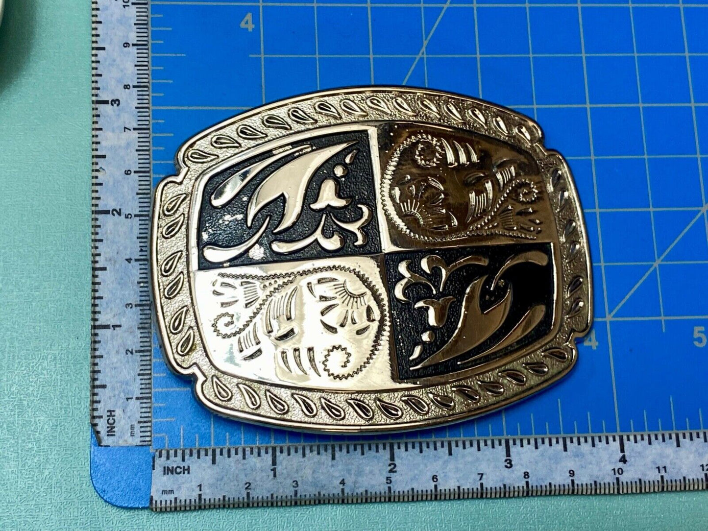 black and silver color western flower swirl outlined cowboy's belt buckle