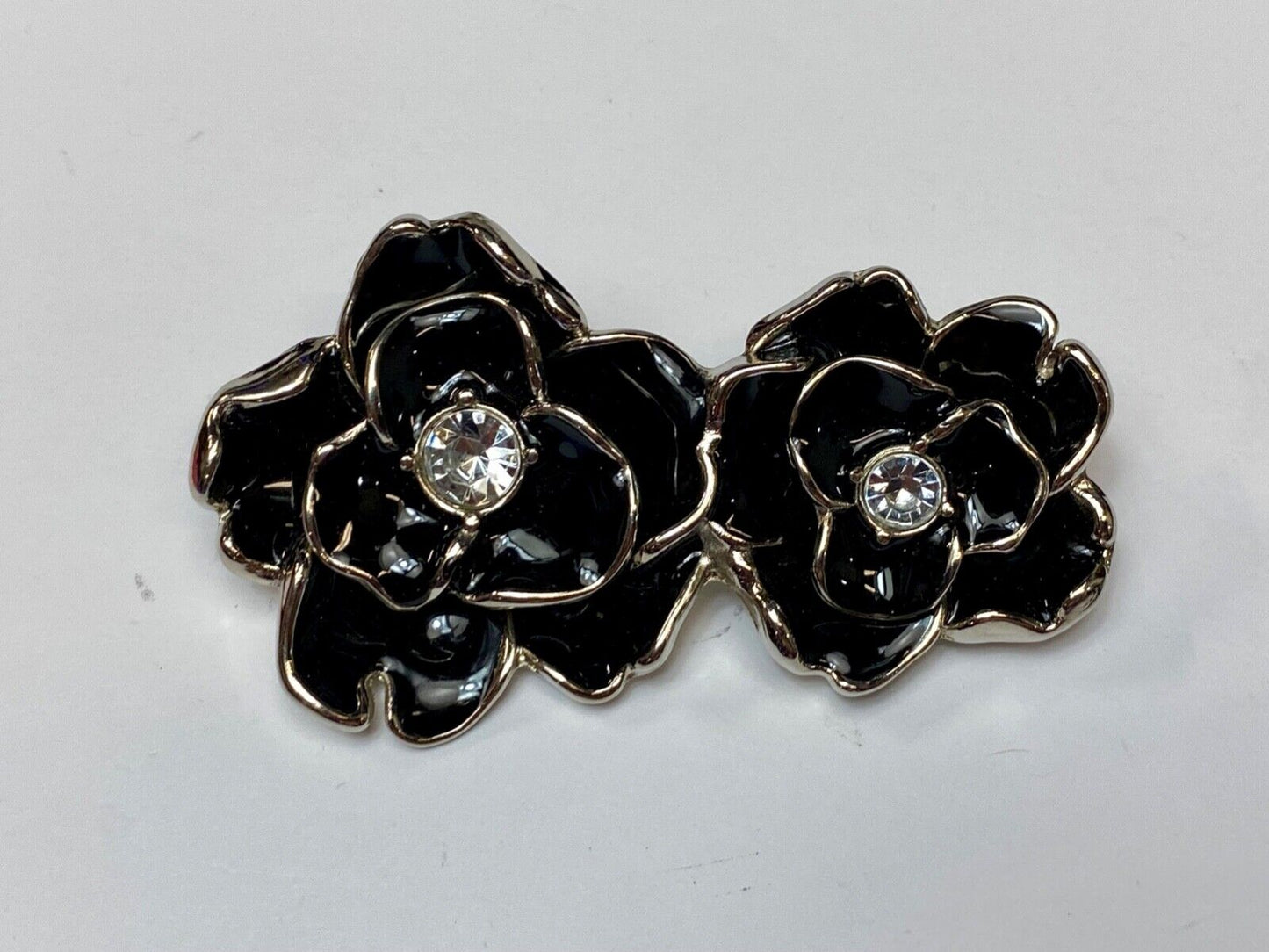 Beautiful two figural flowers with jewels as black & silver colored belt buckle