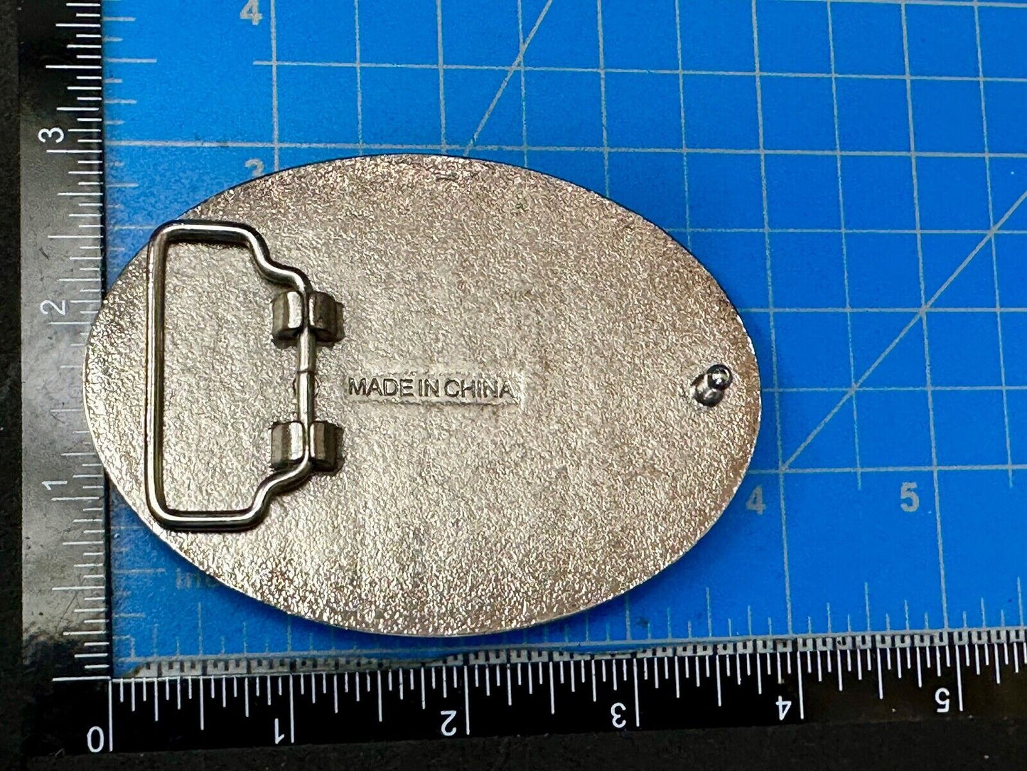 Black and silver Belt Buckle with multiple skulls on boarder