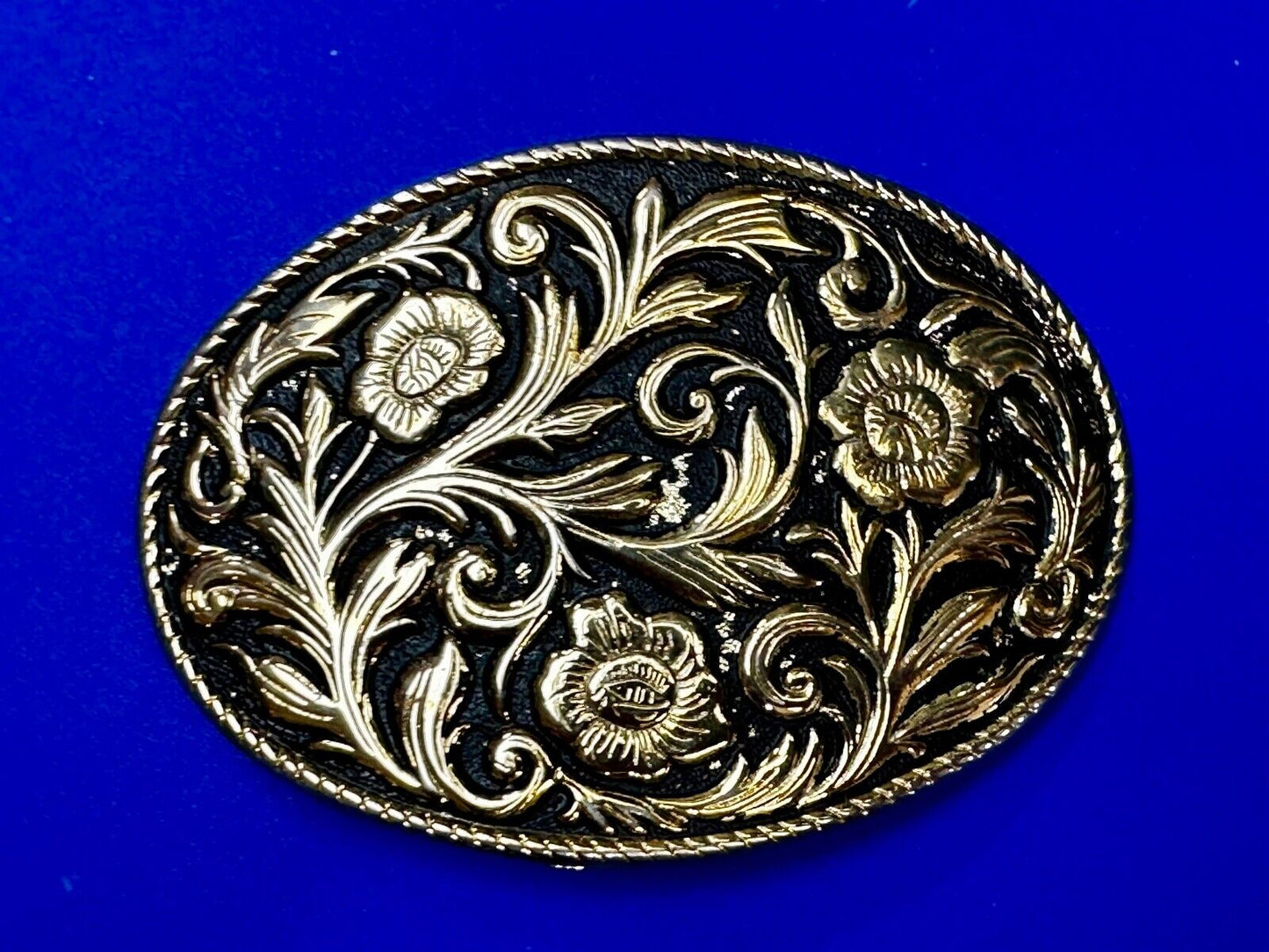 Vintage black and gold tone western flower floral theme cowboys belt buckle