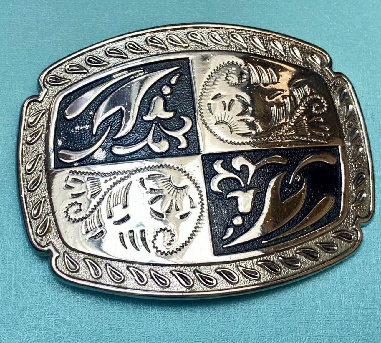 black and silver color western flower swirl outlined cowboy's belt buckle