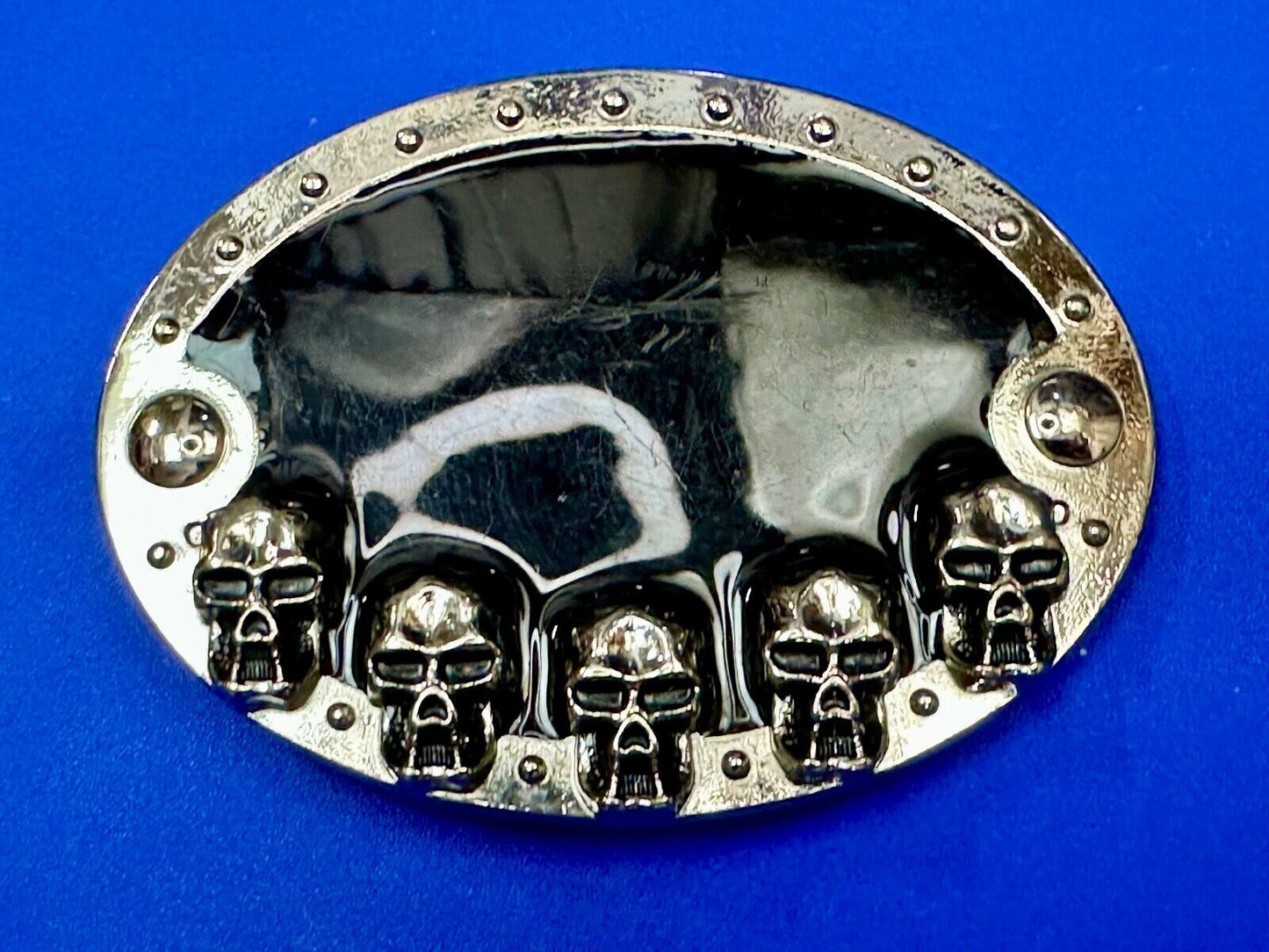 Black and silver Belt Buckle with multiple skulls on boarder
