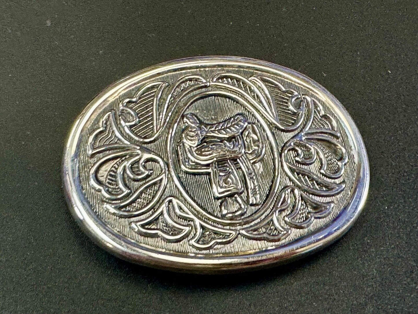 Vintage Cowboy's Horse Saddle ornate flower swirl oval belt buckle by Avon