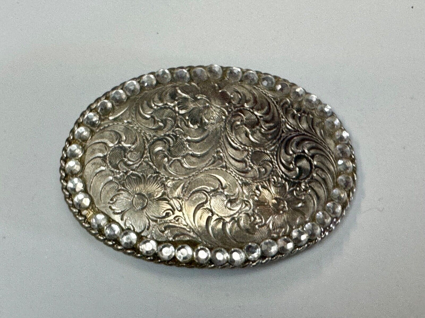 vintage 1996 western flower swirl oval belt buckle with rhinestone boarder