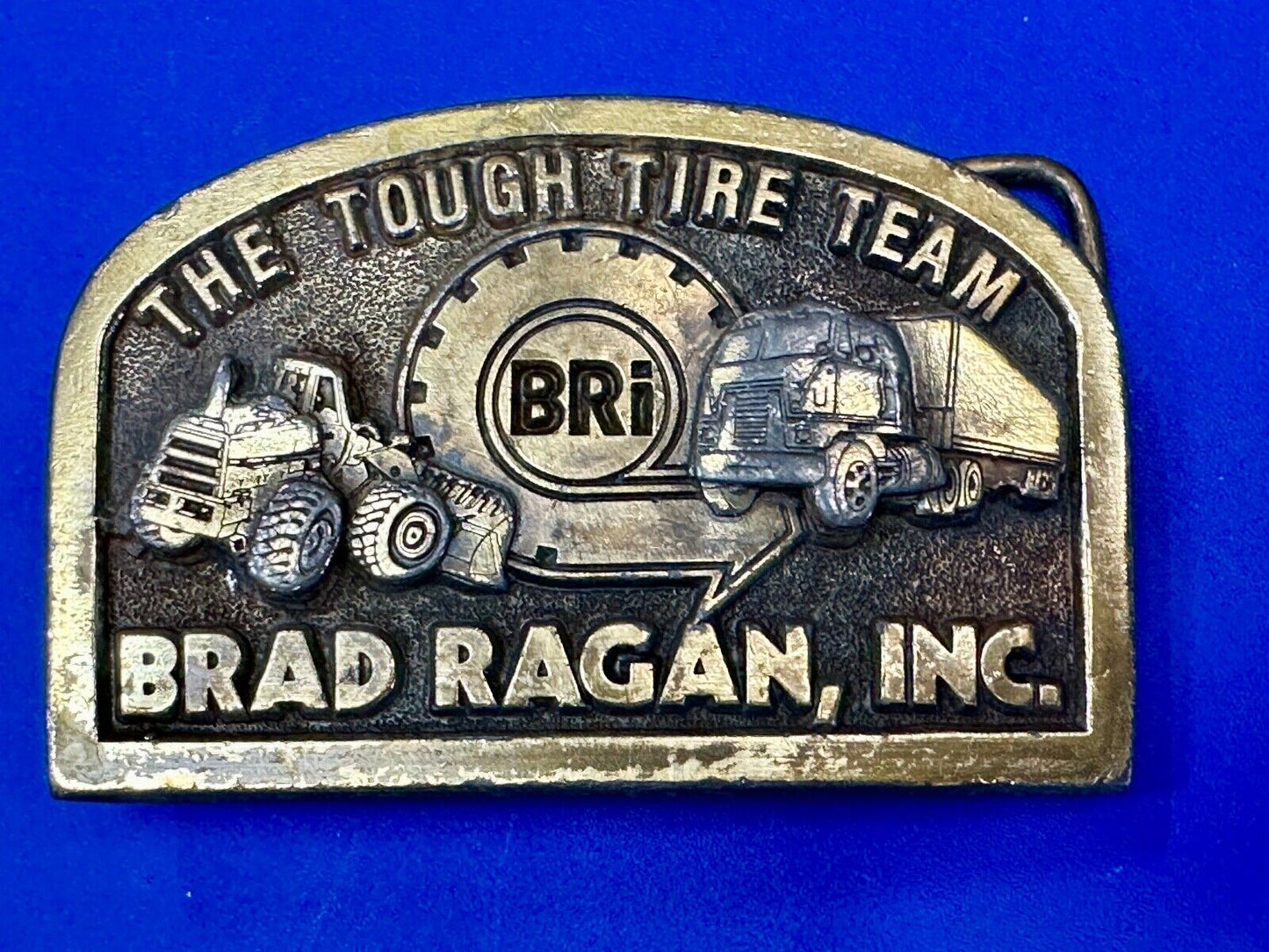 The Tough Tire Team BRi Brad Ragan, Inc. vintage belt buckle by Spec-Cast