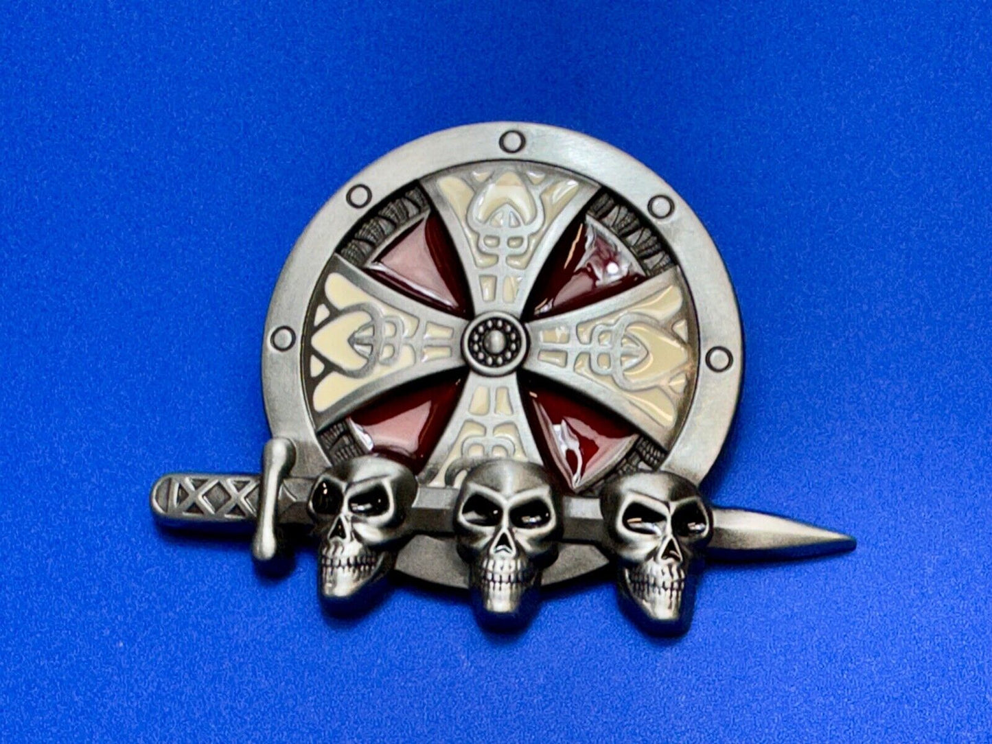 Three skulls with sword through heads on Iron Cross round NOS belt buckle