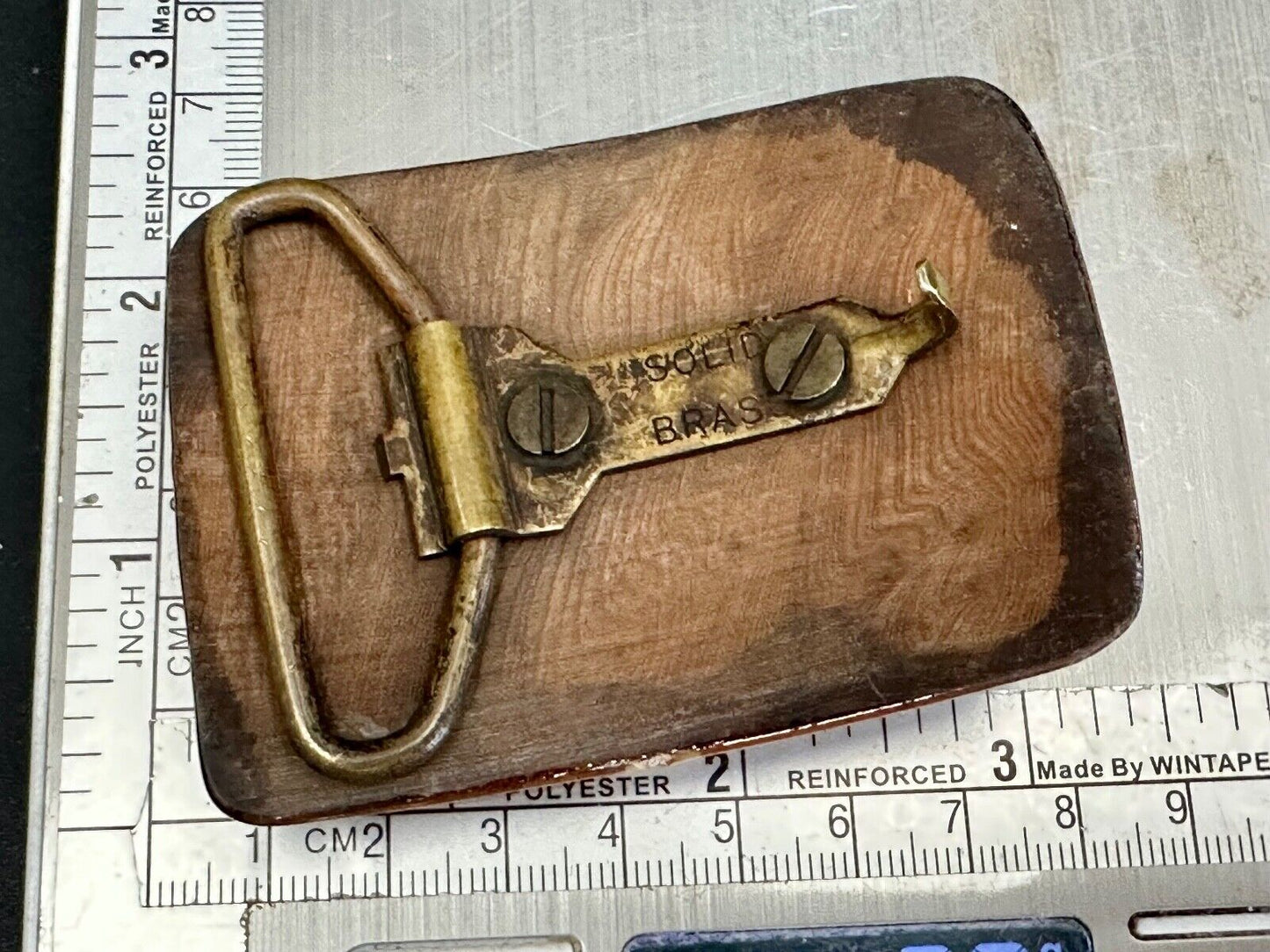 Artisan wooden glossy wood belt buckle with gold color artist scene?