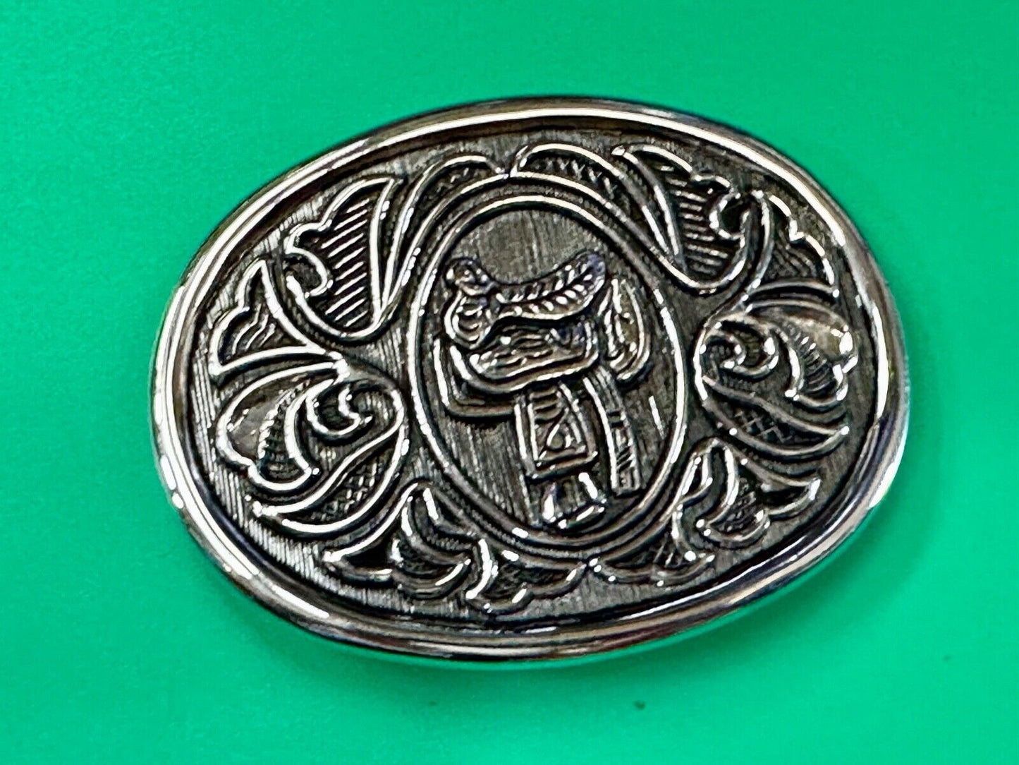 Vintage Cowboy's Horse Saddle ornate flower swirl oval belt buckle by Avon