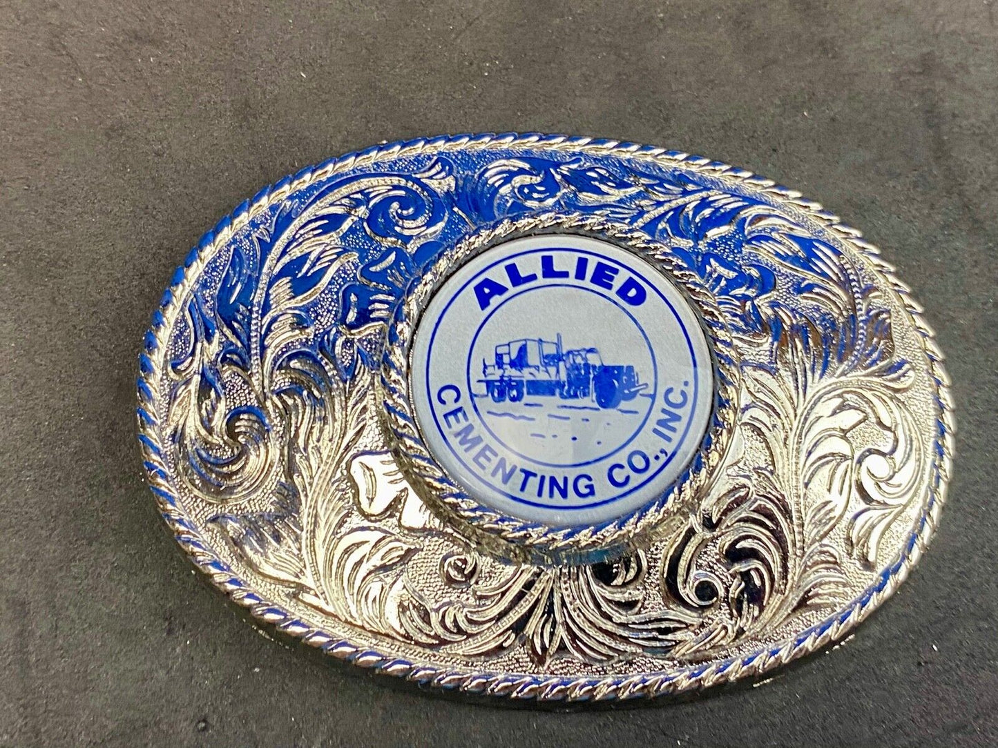 Beautiful belt buckle with centerpiece picture of Allied Cementing Company