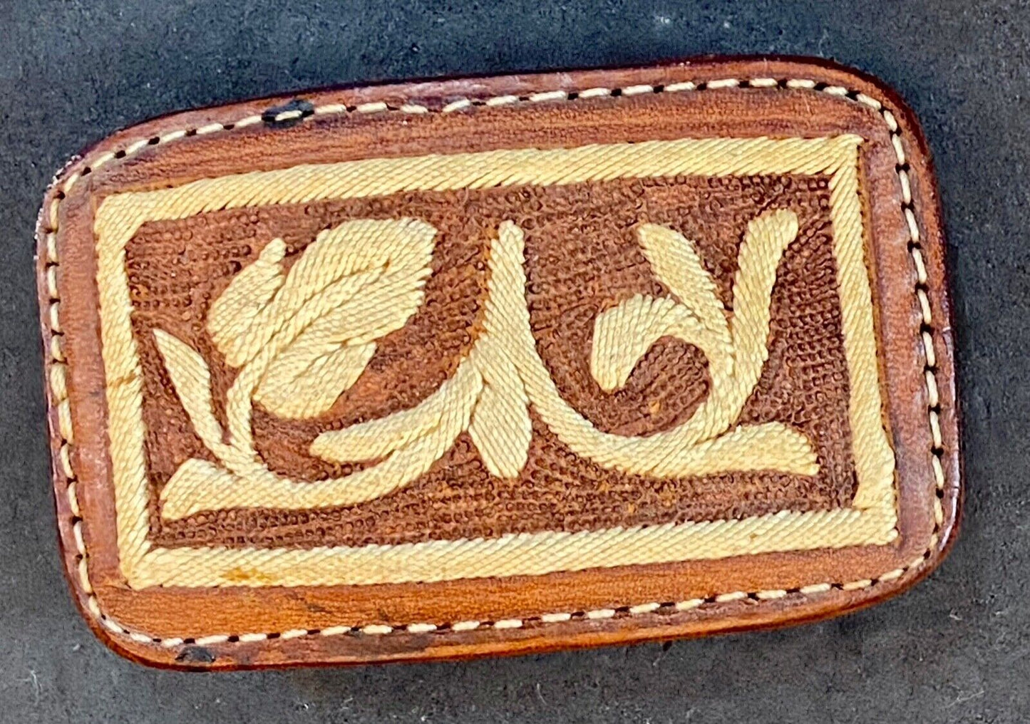 Vintage embroidered flower theme on brown leather belt buckle