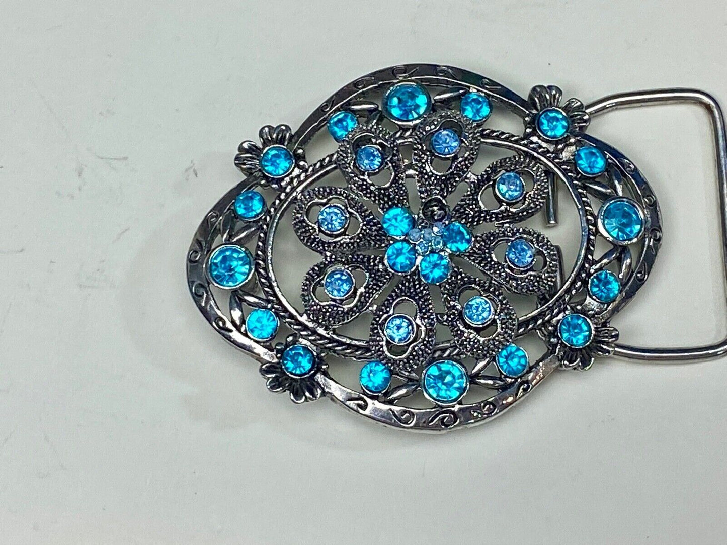 BEAUTIFUL BLUE rhinestones mounted in oval shaped flower theme belt buckle