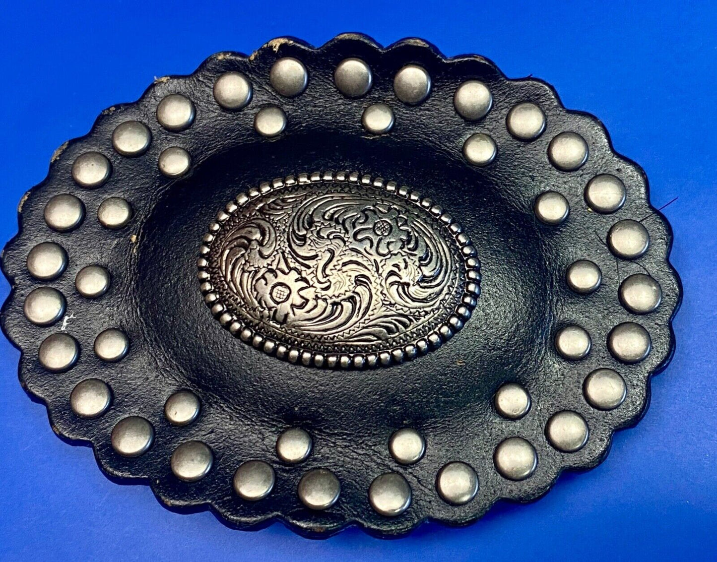 4" wide studded black leather oval belt buckle with flower swirl center