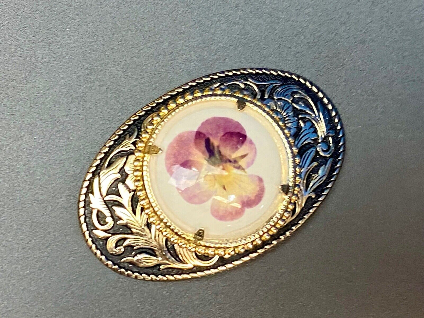 Beautiful pressed purple Violet flower as centerpiece in western belt buckle