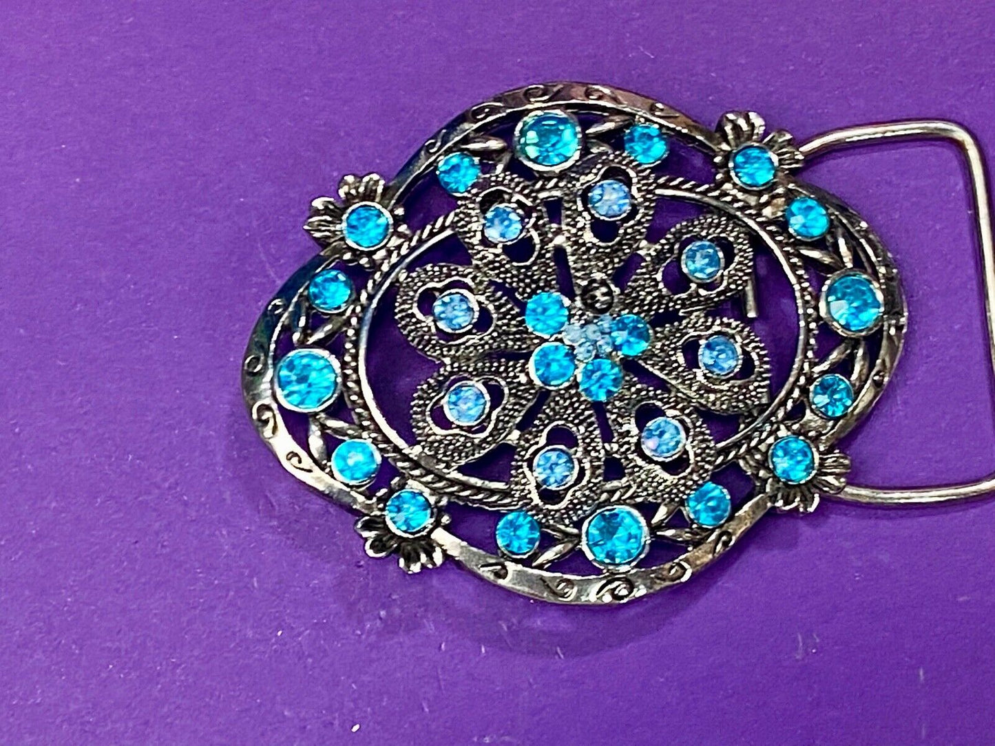 BEAUTIFUL BLUE rhinestones mounted in oval shaped flower theme belt buckle