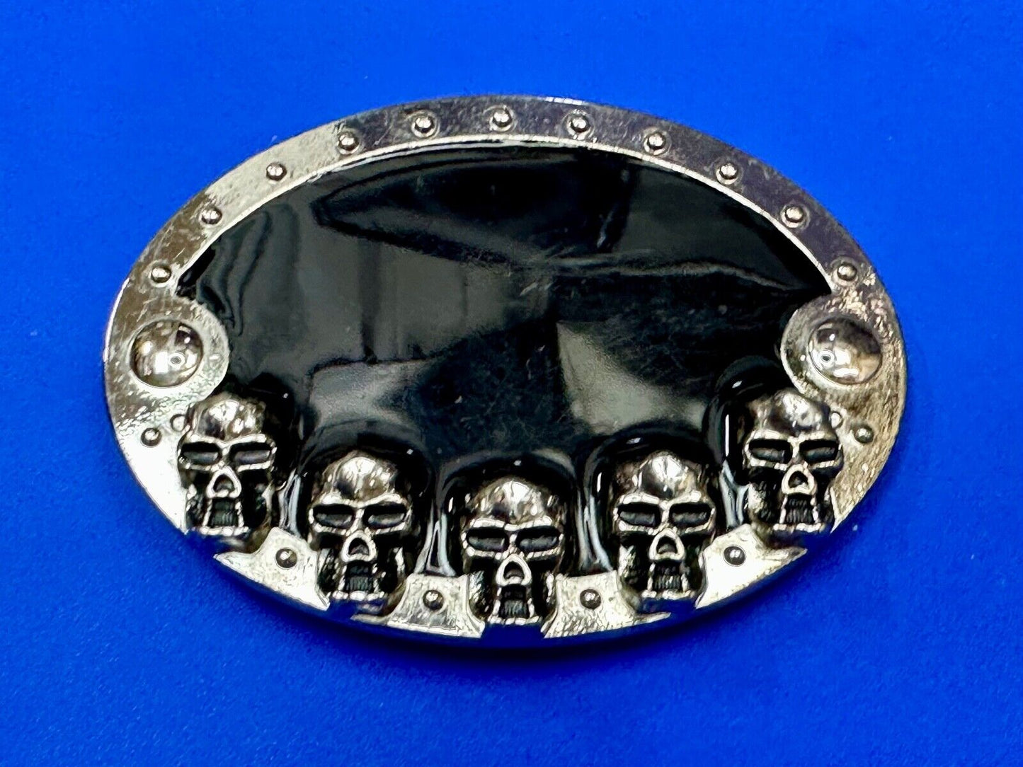 Black and silver Belt Buckle with multiple skulls on boarder