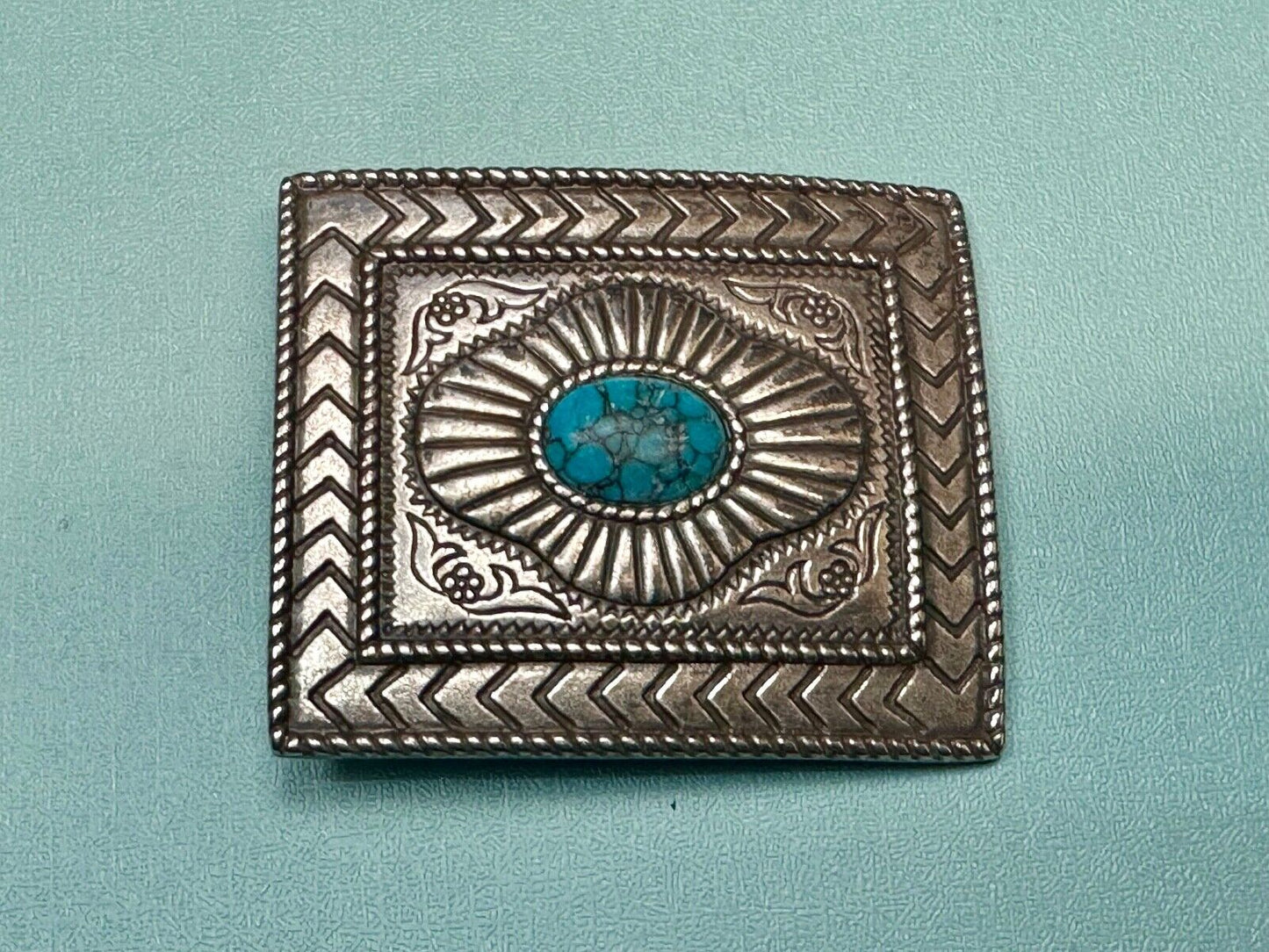 Turquoise Cab centerpiece on southwestern pattern silver tone belt buckle