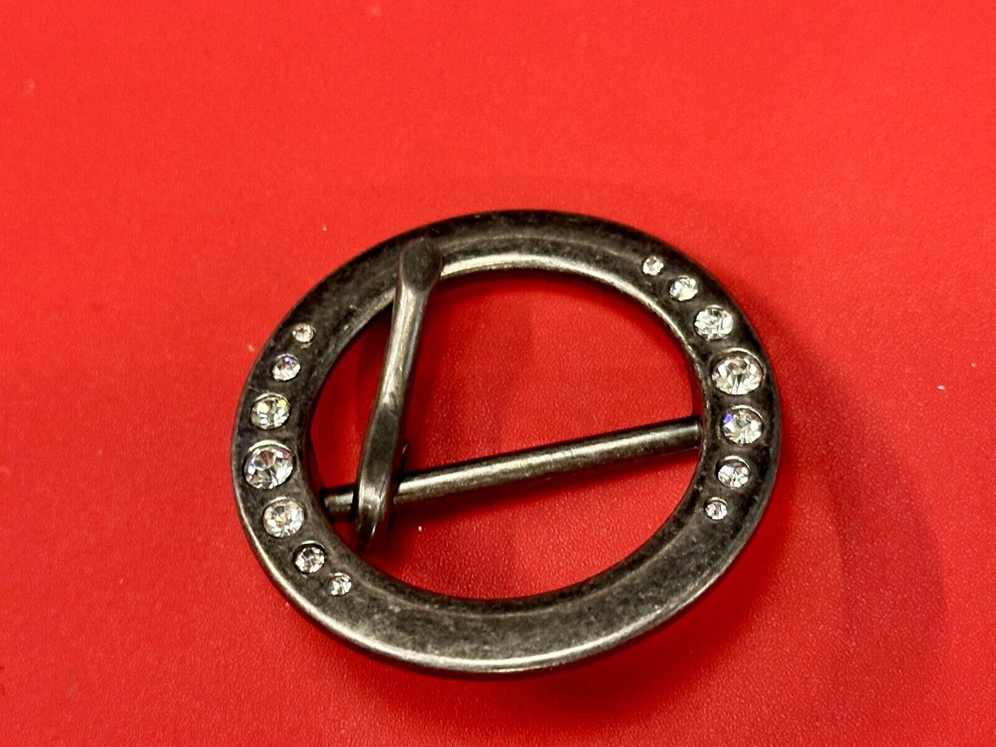 2" Round silver tone belt buckle with graduated rhinestone sized