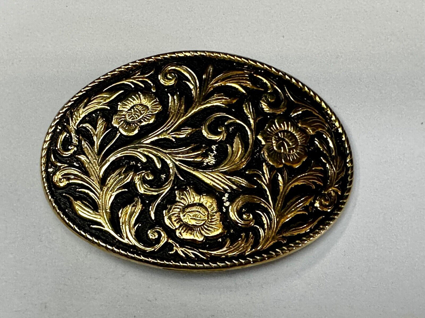 Vintage black and gold tone western flower floral theme cowboys belt buckle