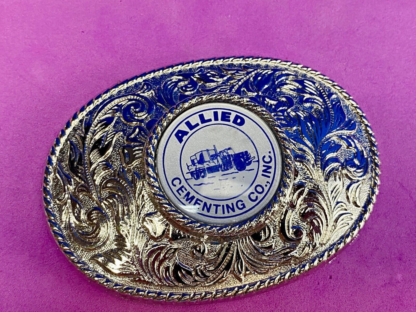 Beautiful belt buckle with centerpiece picture of Allied Cementing Company