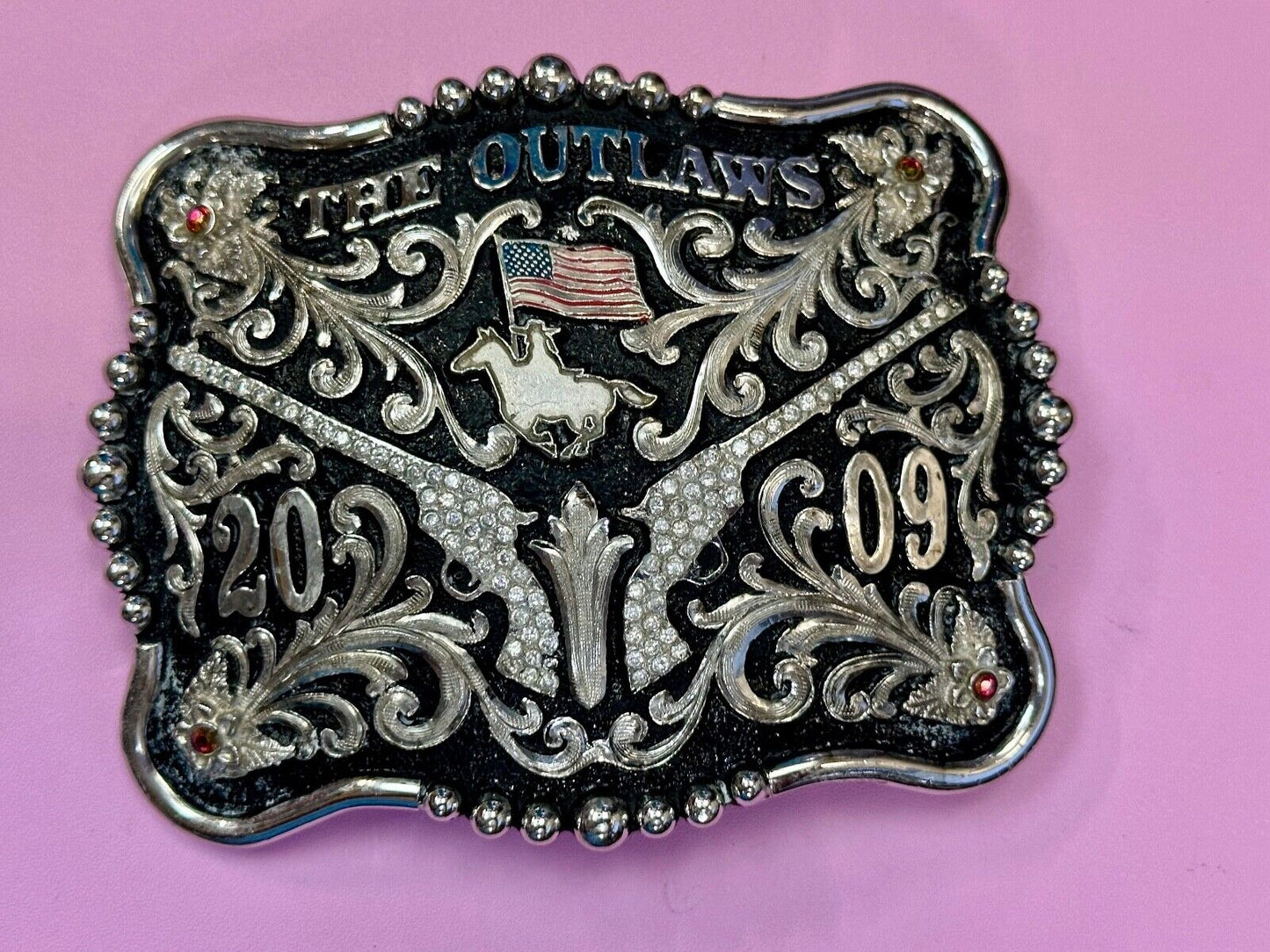 The Outlaws Rodeo Cowboy Trophy 2009 Flag Belt Buckle - Crossroads bucklesTexas