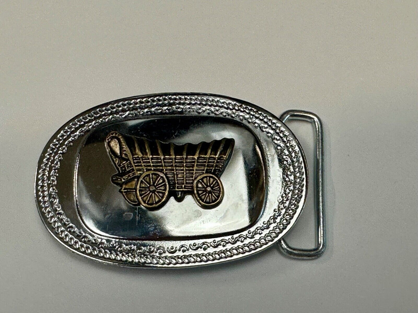 Vintage Covered Wagon on reflective oval two tone western belt buckle