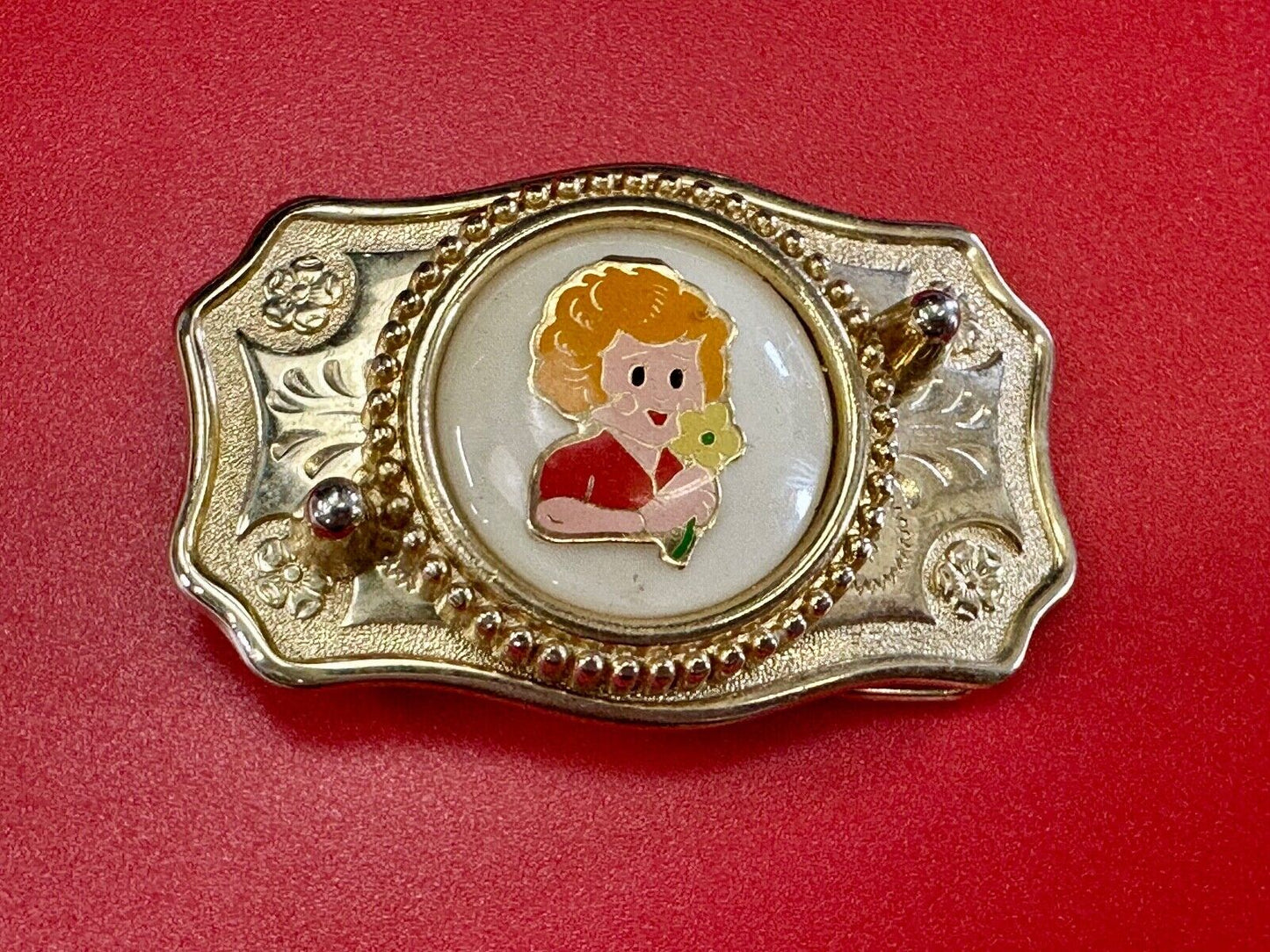 Adorable red headed girl with flower as centerpiece on western belt buckle